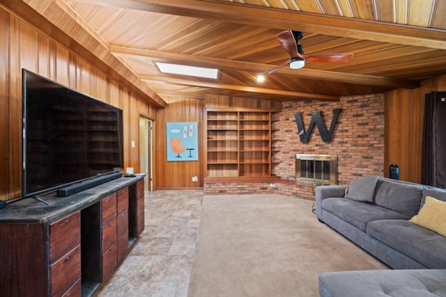 living room featuring wood walls, wood ceiling, a brick fireplace, built in features, and ceiling fan