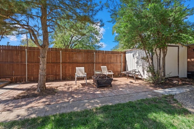 view of patio with an outdoor fire pit and a shed