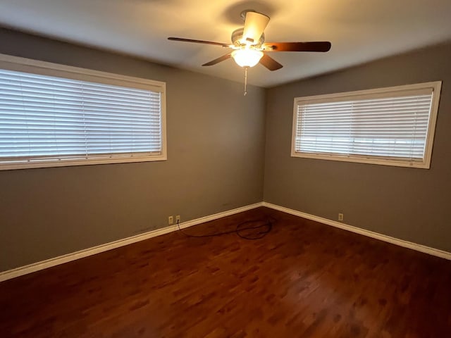 empty room with ceiling fan, vaulted ceiling, and hardwood / wood-style floors