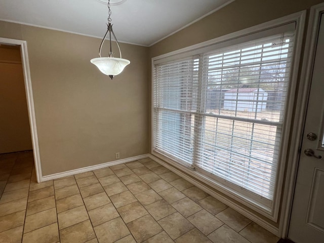 unfurnished dining area with crown molding, plenty of natural light, and light tile patterned floors