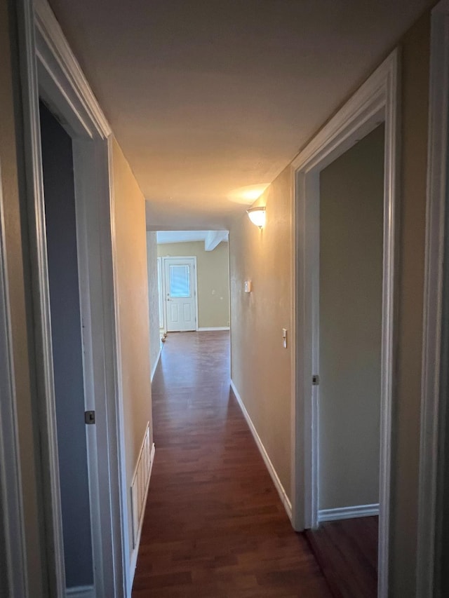 corridor with dark hardwood / wood-style floors