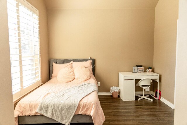 bedroom with dark wood-type flooring