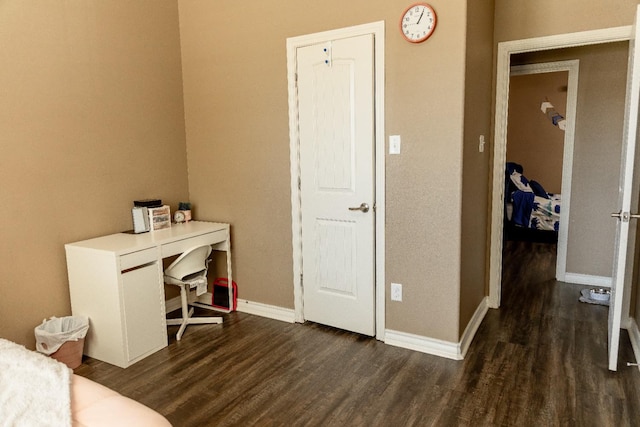 office space with dark wood-type flooring