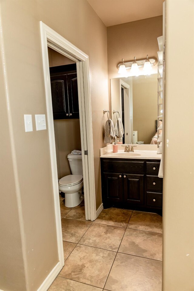 bathroom with vanity, tile patterned floors, and toilet