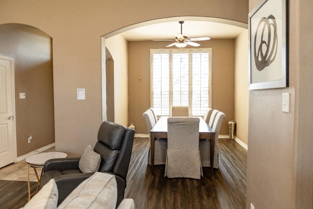 dining area with ceiling fan and dark hardwood / wood-style floors