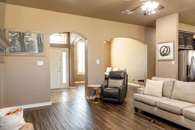 living room with ceiling fan and dark hardwood / wood-style flooring