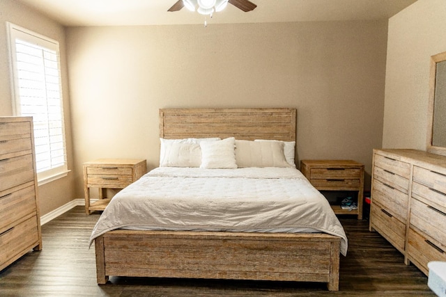 bedroom with ceiling fan, dark hardwood / wood-style floors, and multiple windows