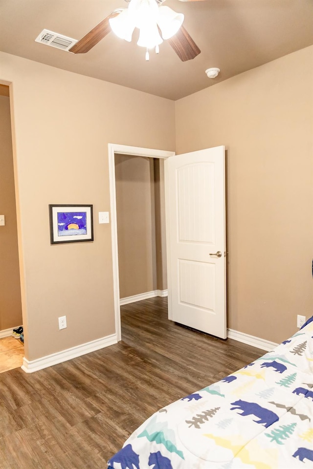 bedroom featuring ceiling fan and dark hardwood / wood-style flooring