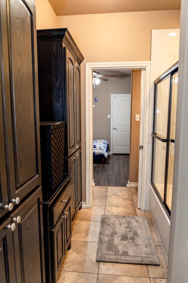 bathroom with ceiling fan, enclosed tub / shower combo, and tile patterned flooring