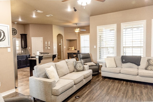 living room featuring hardwood / wood-style floors and ceiling fan