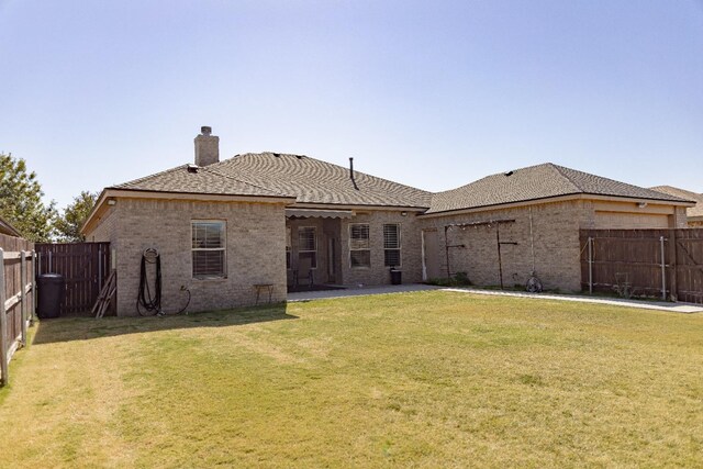 rear view of house with a yard