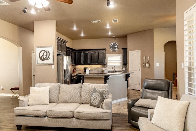 living room featuring wood-type flooring and ceiling fan