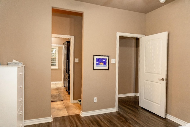 unfurnished bedroom with dark hardwood / wood-style flooring