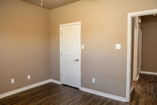 spare room featuring dark wood-type flooring