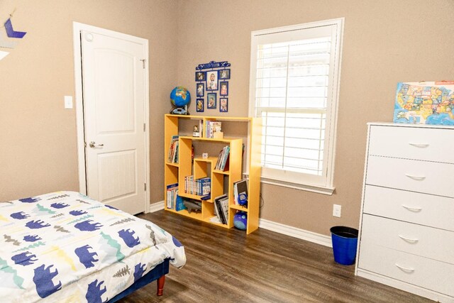 bedroom with dark hardwood / wood-style floors