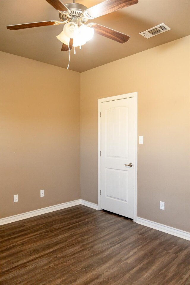 unfurnished room with dark hardwood / wood-style floors and ceiling fan