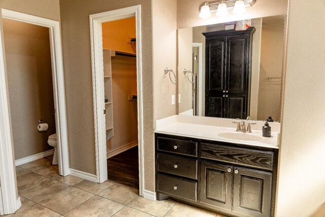 bathroom featuring tile patterned floors, toilet, and vanity