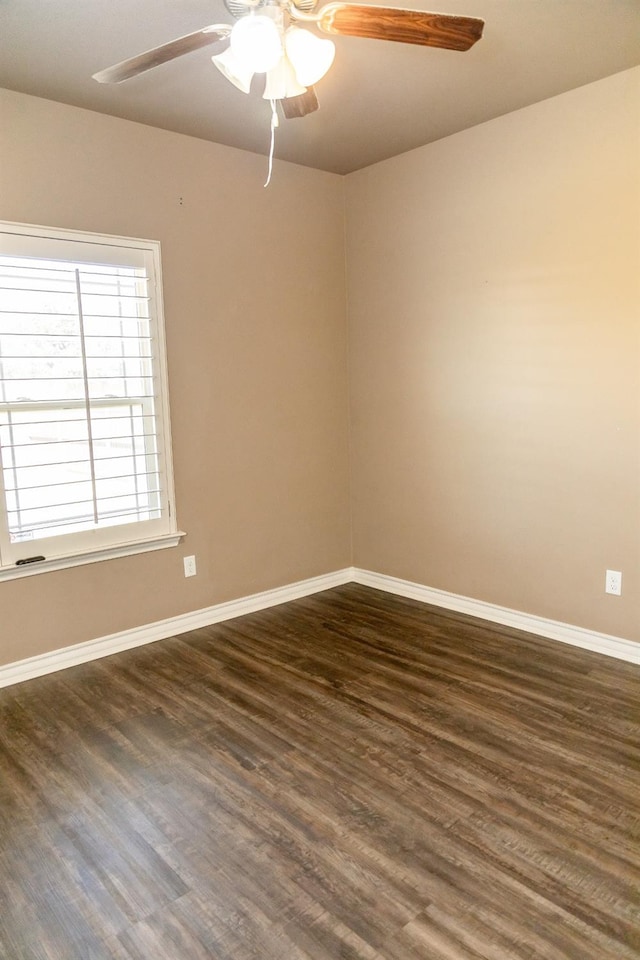 spare room featuring dark wood-type flooring and ceiling fan