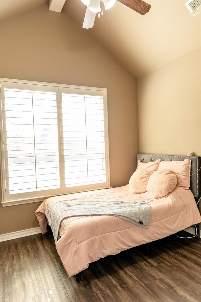 bedroom featuring lofted ceiling with beams, hardwood / wood-style floors, and ceiling fan