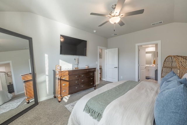 bedroom with ensuite bathroom, lofted ceiling, light colored carpet, and ceiling fan