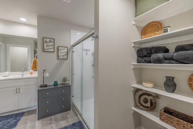 bathroom with vanity, hardwood / wood-style floors, and walk in shower