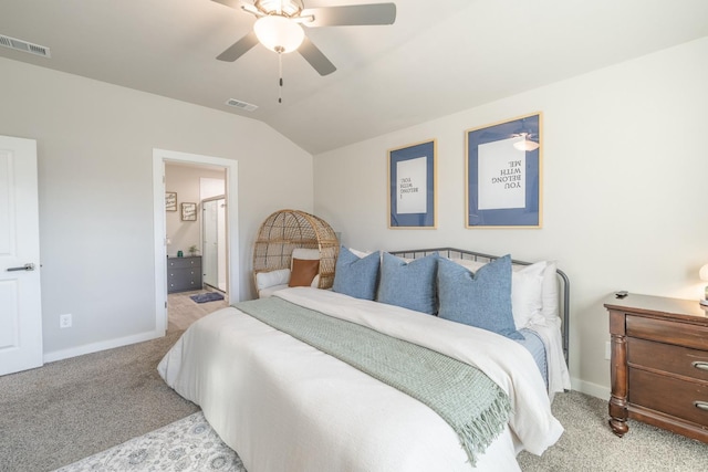 bedroom with ceiling fan, lofted ceiling, ensuite bathroom, and light carpet