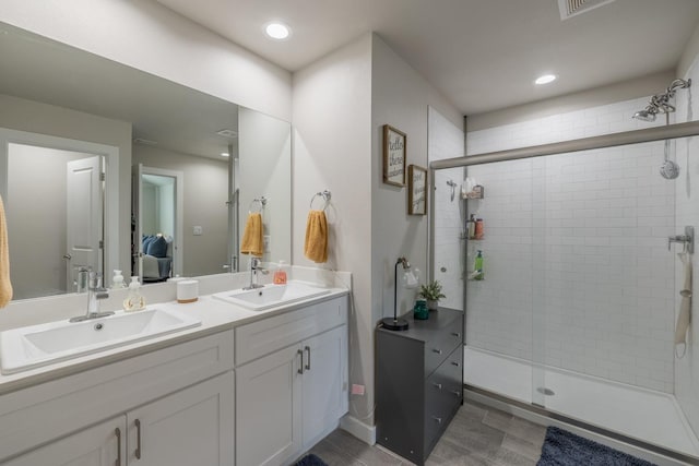 bathroom featuring walk in shower and vanity