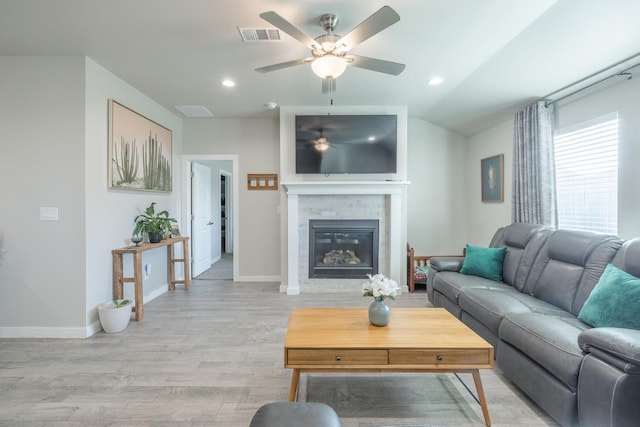 living room featuring vaulted ceiling, ceiling fan, and light wood-type flooring