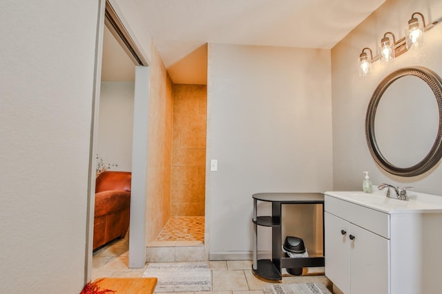 bathroom featuring vanity, tile patterned floors, and tiled shower