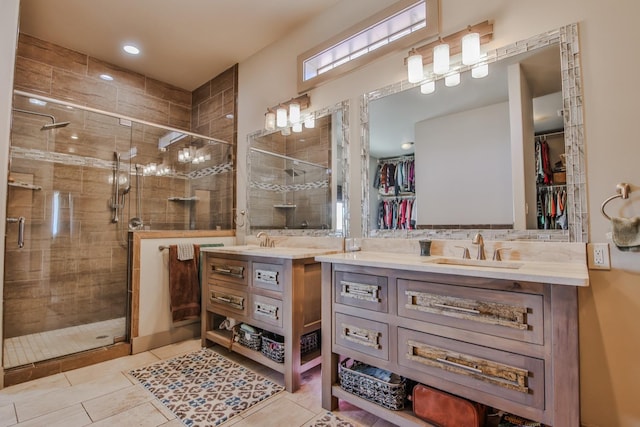 bathroom with an enclosed shower, vanity, and tile patterned floors