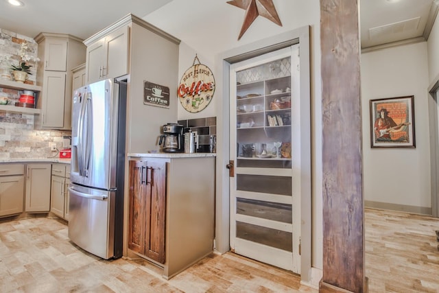 kitchen with tasteful backsplash, stainless steel fridge with ice dispenser, and light hardwood / wood-style flooring