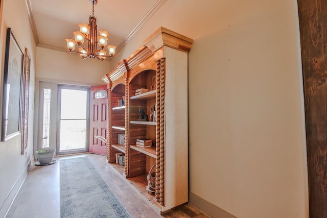 mudroom featuring crown molding and an inviting chandelier