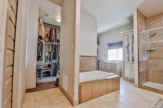 bathroom with plus walk in shower and tile patterned flooring