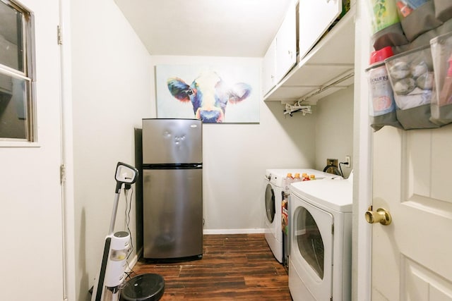 washroom featuring cabinets, dark wood-type flooring, and washer and clothes dryer