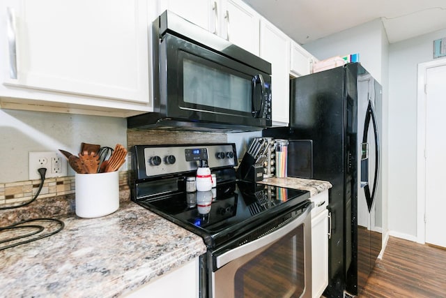 kitchen featuring white cabinetry, dark hardwood / wood-style floors, light stone counters, and black appliances