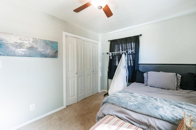 carpeted bedroom featuring a closet and ceiling fan