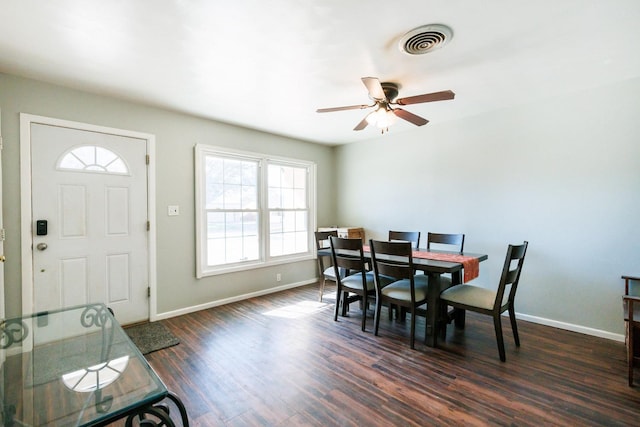 dining area featuring dark wood-type flooring and ceiling fan