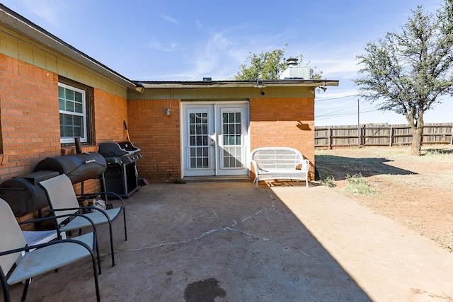 view of patio with french doors and a grill