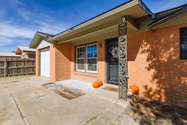 view of exterior entry with a garage