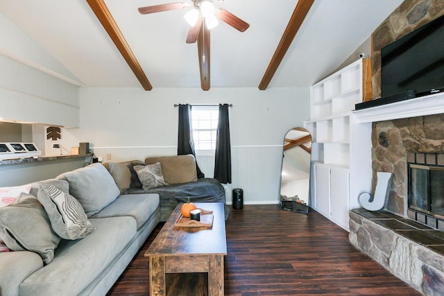 living room with ceiling fan, a fireplace, dark hardwood / wood-style flooring, and lofted ceiling with beams