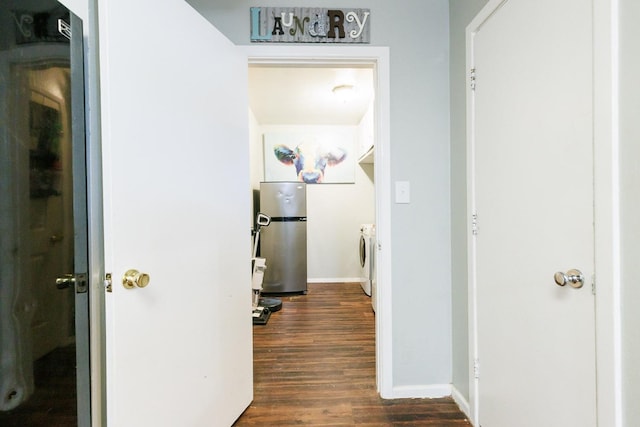 corridor with washer and dryer and dark hardwood / wood-style flooring