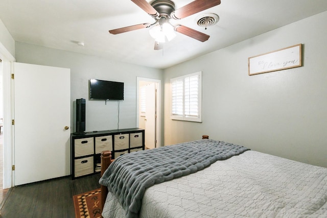 bedroom with dark hardwood / wood-style floors and ceiling fan