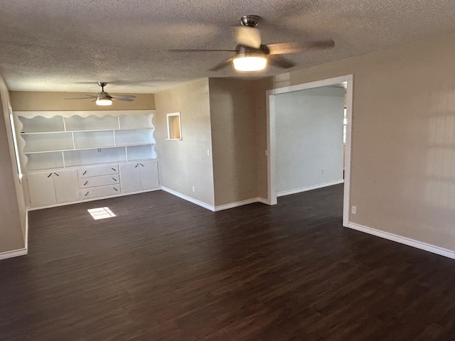 727 E 12th St, Littlefield, TX 79339 - spare room featuring ceiling fan, dark wood finished floors, a textured ceiling, and baseboards