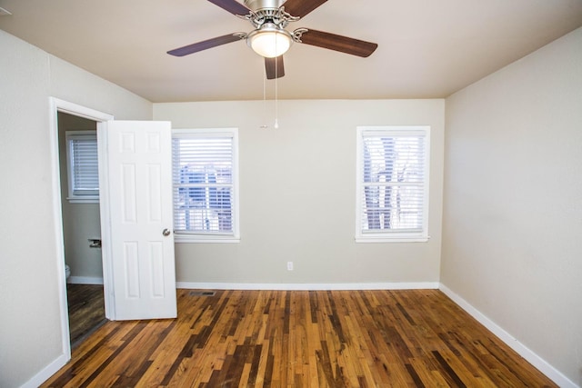 unfurnished bedroom with ceiling fan and dark hardwood / wood-style floors