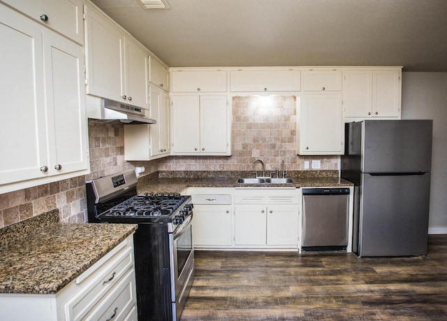 kitchen with dark wood-type flooring, sink, white cabinetry, tasteful backsplash, and stainless steel appliances