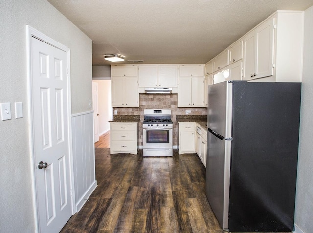 kitchen featuring white cabinetry, appliances with stainless steel finishes, dark hardwood / wood-style floors, and backsplash