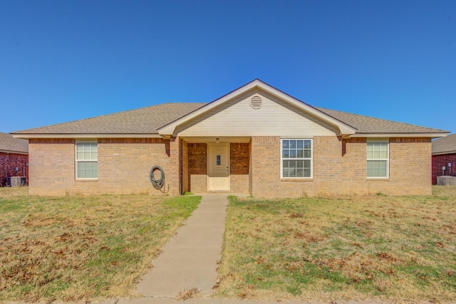 single story home with a front lawn and central air condition unit