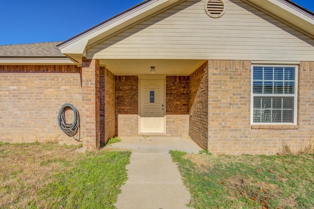 property entrance with a yard