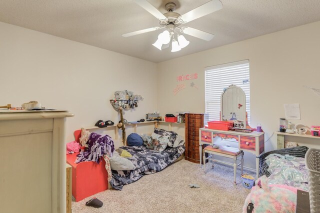 bedroom featuring carpet flooring, a textured ceiling, and ceiling fan