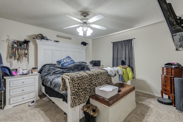 bedroom with light carpet, ceiling fan, and a textured ceiling